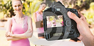 Composite image of cropped hand of photographer holding camera