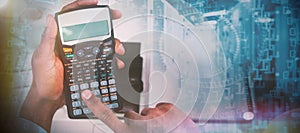 Composite image of cropped hands of businessman using calculator