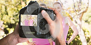 Composite image of cropped image of hands holding camera