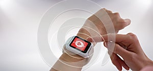 Composite image of cropped image of hands using smart watch