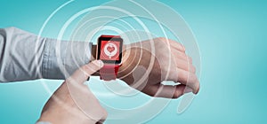 Composite image of cropped image of man using smart watch