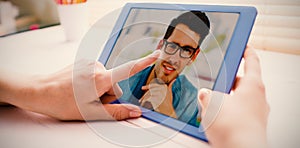 Composite image of cropped image of person using on digital tablet