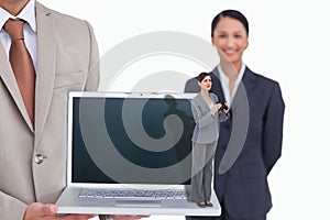 Composite image of curious young businesswoman with binoculars