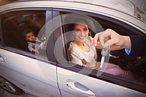 Composite image of customer receiving car keys