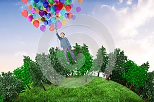 Composite image of cute boy holding balloons