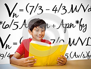 Composite image of cute boy reading book in library