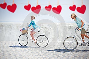 Composite image of cute couple on a bike ride
