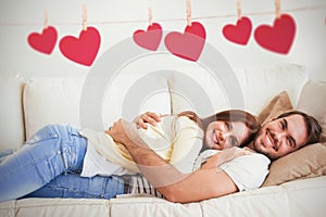 Composite image of cute couple relaxing on couch