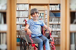 Composite image of cute disabled pupil smiling at camera in hall