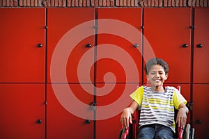 Composite image of cute disabled pupil smiling at camera in hall