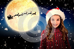 Composite image of cute girl in santa hat