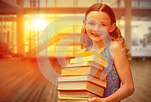 Composite image of cute little girl carrying books in library