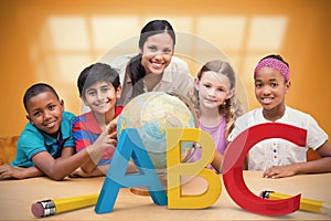 Composite image of cute pupils and teacher looking at globe in library