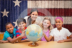 Composite image of cute pupils and teacher looking at globe in library