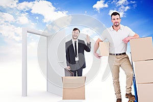 Composite image of delivery man with trolley of boxes