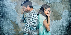 Composite image of depressed couple standing back to back