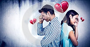 Composite image of depressed couple standing back to back