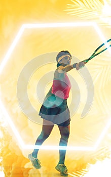 Composite image of determined young african american female athlete playing tennis over leaf pattern