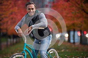 Composite image of digital composite of handsome man on a bike ride