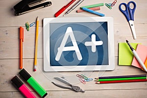 Composite image of digital tablet on students desk