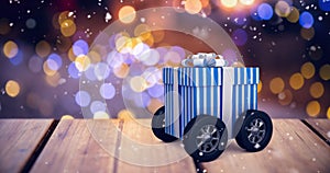 Composite image of digitally generated image of gift box with wheels