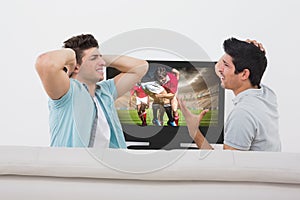 Composite image of disappointed soccer fans watching tv