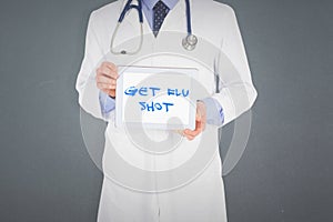 Composite image of doctor showing digital tablet on white background