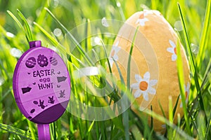 Composite image of easter egg hunt sign