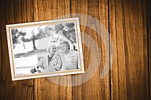 Composite image of elderly couple with their bikes