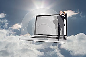 Composite image of elegant businessman standing and using binoculars