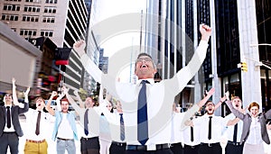 Composite image of excited businessman with glasses cheering