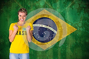 Composite image of excited football fan in brasil tshirt