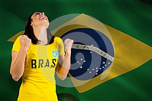 Composite image of excited football fan in brasil tshirt