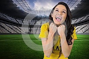 Composite image of excited football fan in brasil tshirt