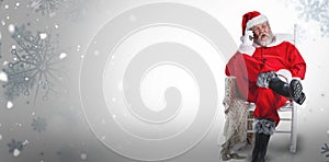 Composite image of excited santa claus talking on mobile phone