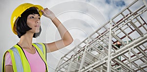 Composite image of female architect in hard hat looking away against white background