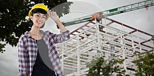 Composite image of female architect in hard hat standing against white background