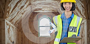 Composite image of female architect holding clipboard and blueprint against grey background