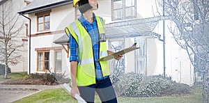 Composite image of female architect holding clipboard and blueprint against grey background