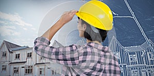 Composite image of female architect wearing hard hat against white background