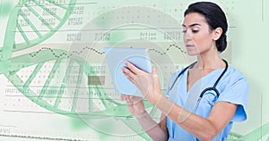 Composite image of female doctor using digital tablet
