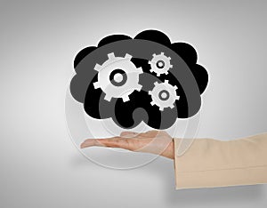 Composite image of female hand presenting cogs and wheels