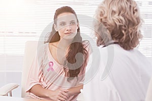 Composite image of female patient listening to doctor with concentration in medical office