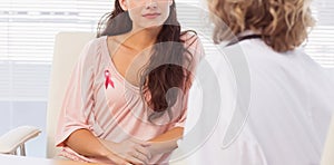 Composite image of female patient listening to doctor with concentration in medical office