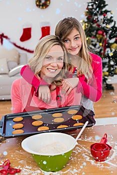 Composite image of festive little girl making christmas cookies