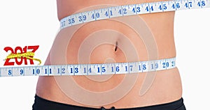 Composite image of fit belly surrounded by measuring tape