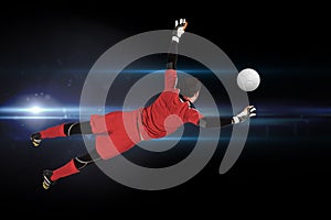 Composite image of fit goal keeper jumping up