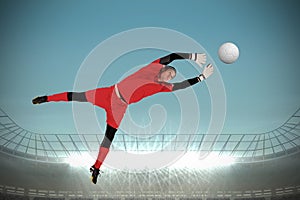 Composite image of fit goal keeper jumping up