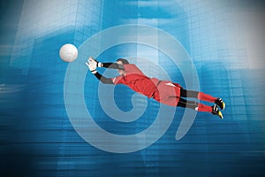 Composite image of fit goal keeper jumping up