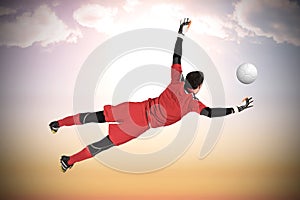 Composite image of fit goal keeper jumping up